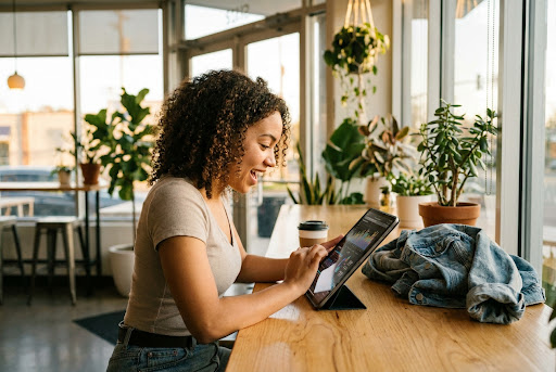 Student learning AI on tablet in a cozy cafe